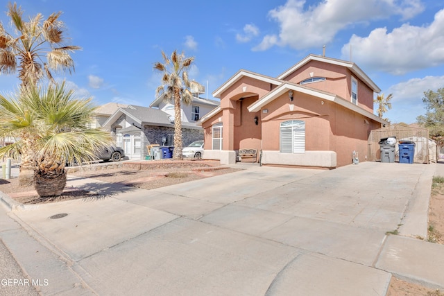 view of front of house with driveway and stucco siding