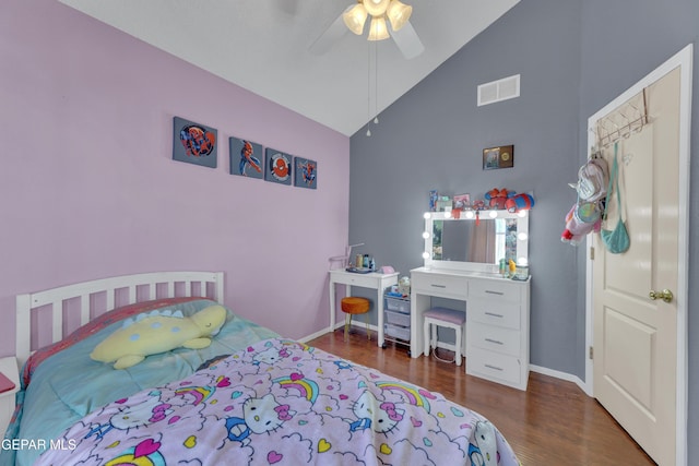 bedroom with visible vents, high vaulted ceiling, wood finished floors, baseboards, and ceiling fan