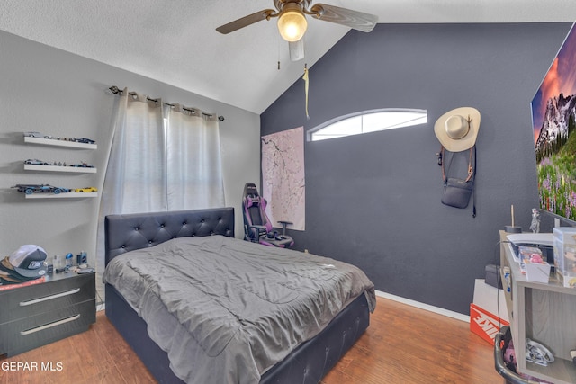 bedroom featuring vaulted ceiling, wood finished floors, baseboards, and ceiling fan