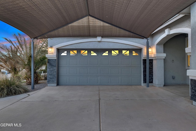 garage featuring concrete driveway