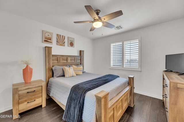 bedroom with ceiling fan, dark wood-style floors, visible vents, and baseboards