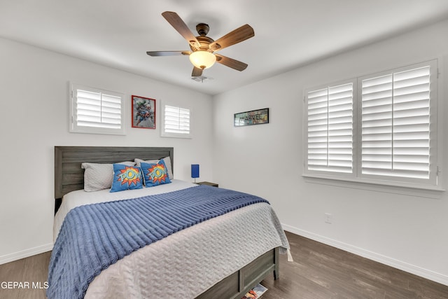 bedroom featuring wood finished floors, baseboards, and ceiling fan