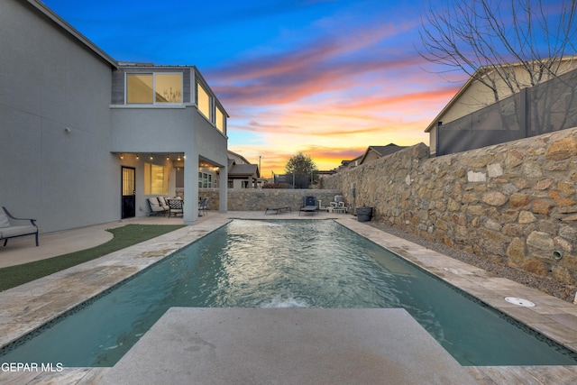 view of swimming pool with a patio area, a fenced in pool, and a fenced backyard