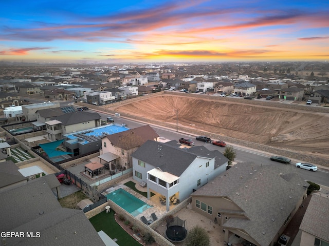 aerial view at dusk featuring a residential view