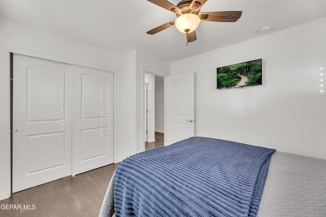 bedroom with a closet, wood finished floors, and a ceiling fan