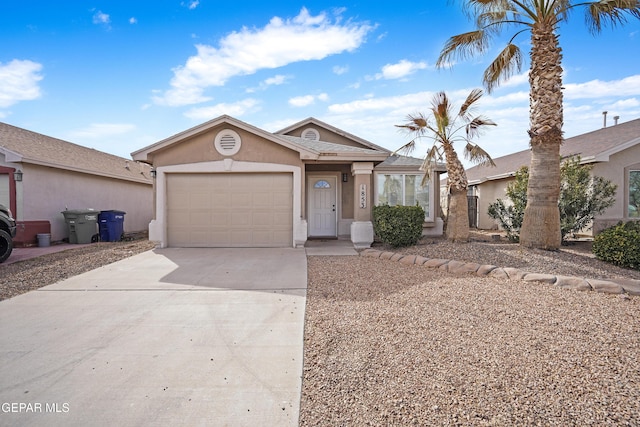 view of front facade with concrete driveway, a garage, and stucco siding