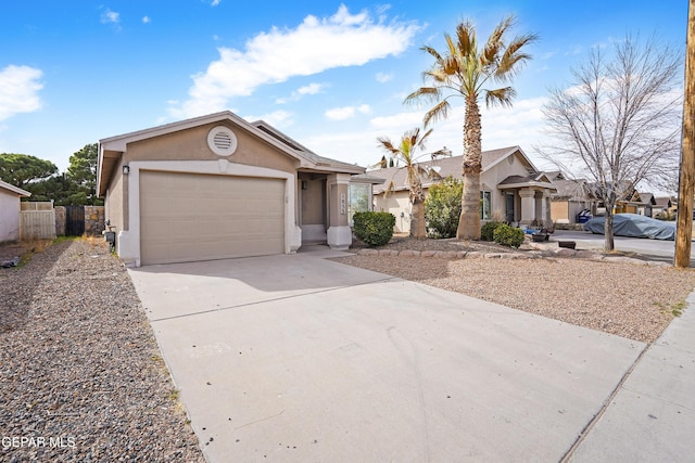 ranch-style house with concrete driveway, an attached garage, fence, and stucco siding