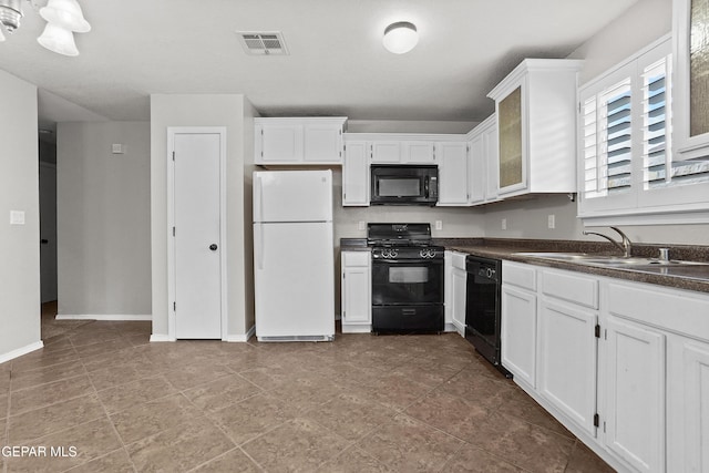 kitchen with visible vents, a sink, black appliances, white cabinets, and dark countertops