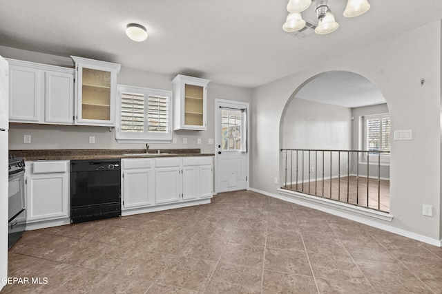 kitchen with dark countertops, white cabinets, and black dishwasher