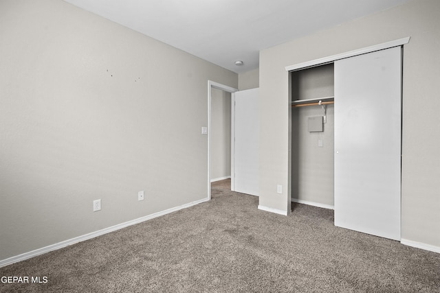 unfurnished bedroom with a closet, baseboards, and carpet