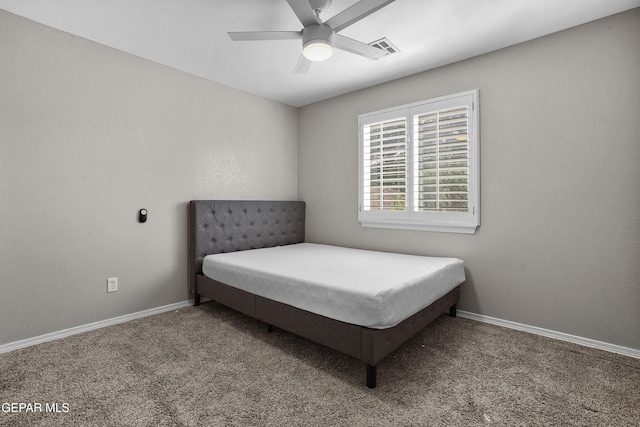 carpeted bedroom with baseboards, visible vents, and ceiling fan