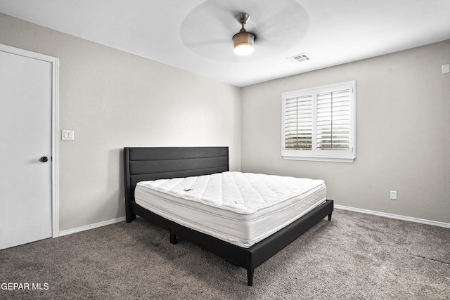 carpeted bedroom featuring baseboards, visible vents, and ceiling fan