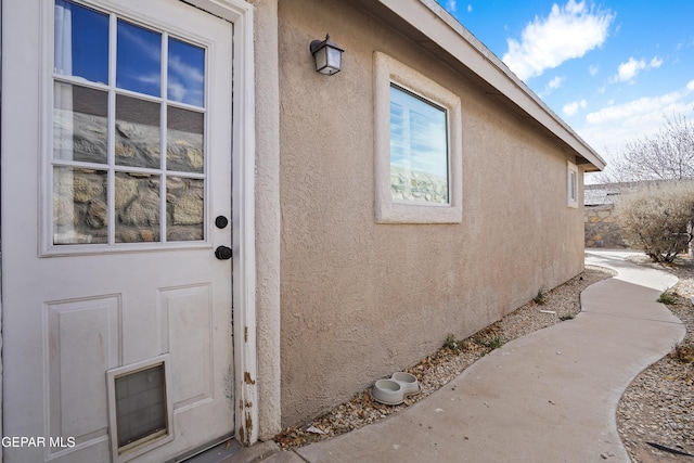 entrance to property with stucco siding