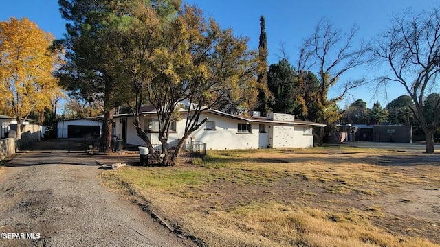 view of front of property featuring stucco siding and fence