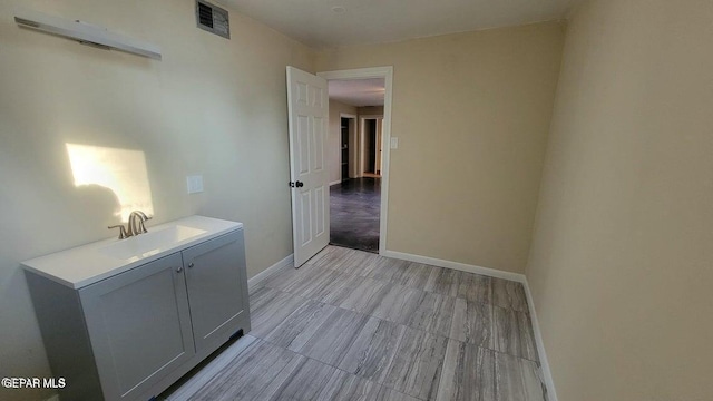 bathroom with visible vents, baseboards, and vanity