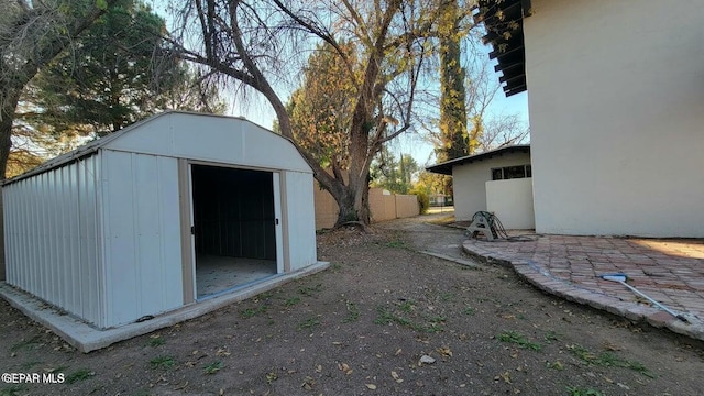 view of shed featuring fence