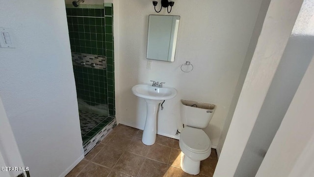 full bath with tile patterned flooring, a stall shower, toilet, and baseboards