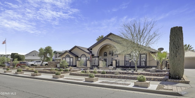 view of front of house featuring a fenced front yard and stucco siding