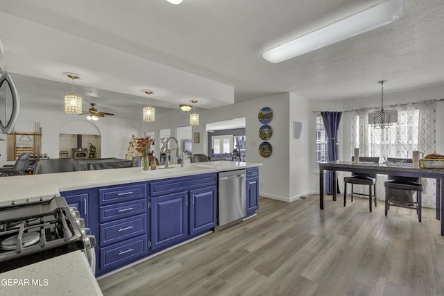 kitchen featuring gas stove, blue cabinetry, a sink, light wood-style floors, and dishwasher