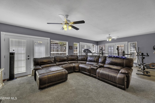 living area with french doors, a textured ceiling, and a ceiling fan