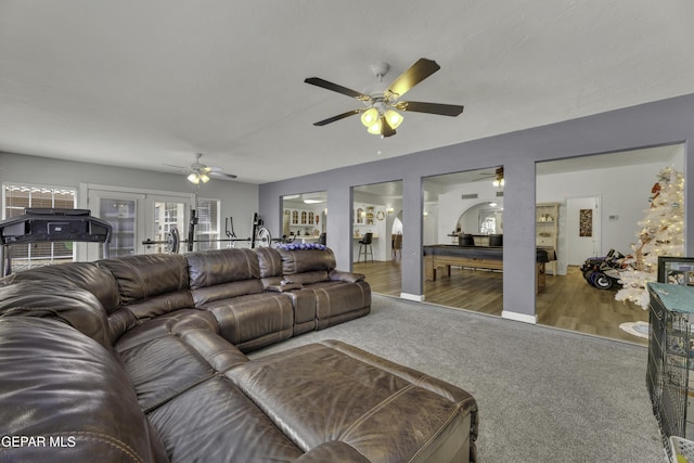 living area featuring french doors, carpet floors, and ceiling fan