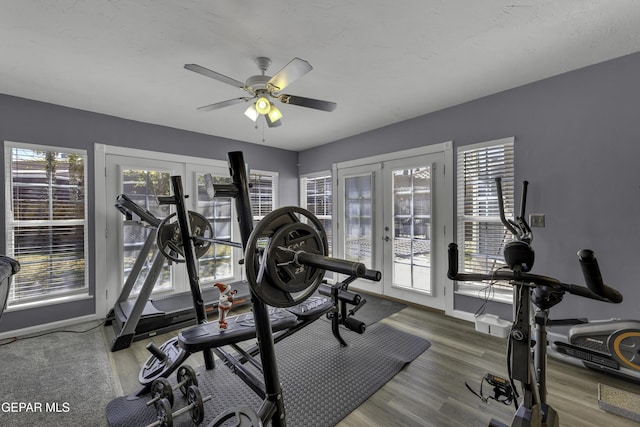 exercise area with a ceiling fan, wood finished floors, french doors, and baseboards