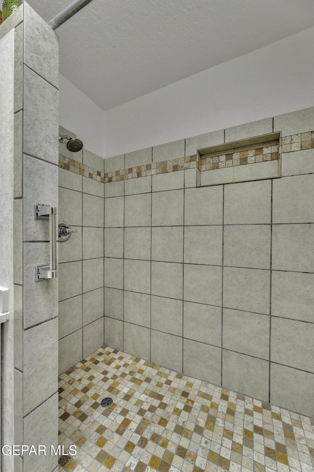 bathroom with a tile shower