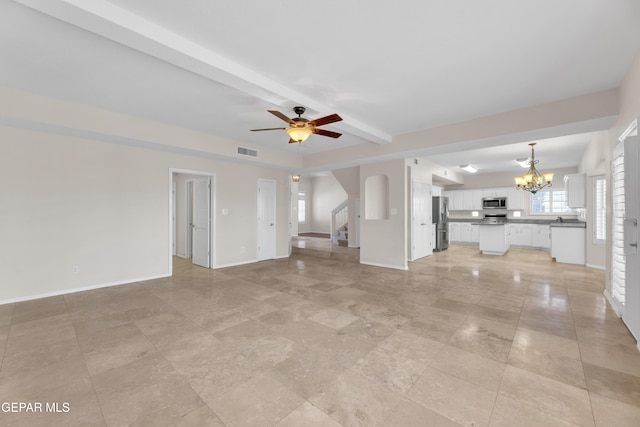 unfurnished living room with visible vents, baseboards, stairs, and ceiling fan with notable chandelier