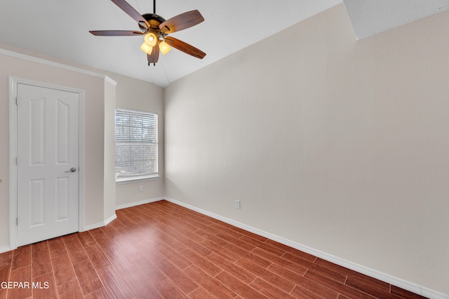 unfurnished room featuring a ceiling fan, wood finished floors, and baseboards