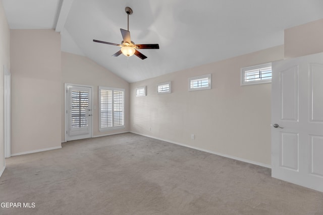 spare room featuring lofted ceiling with beams, baseboards, light carpet, and a ceiling fan