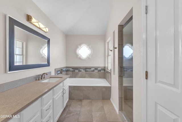 bathroom with tile patterned floors, vanity, a garden tub, and a shower with shower door