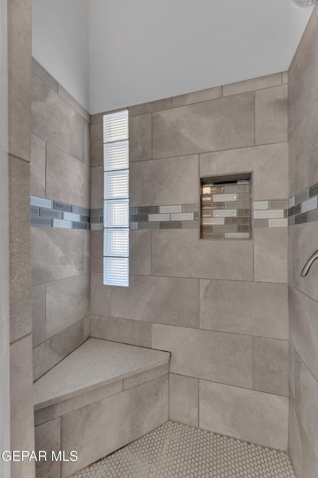 full bathroom featuring tiled shower