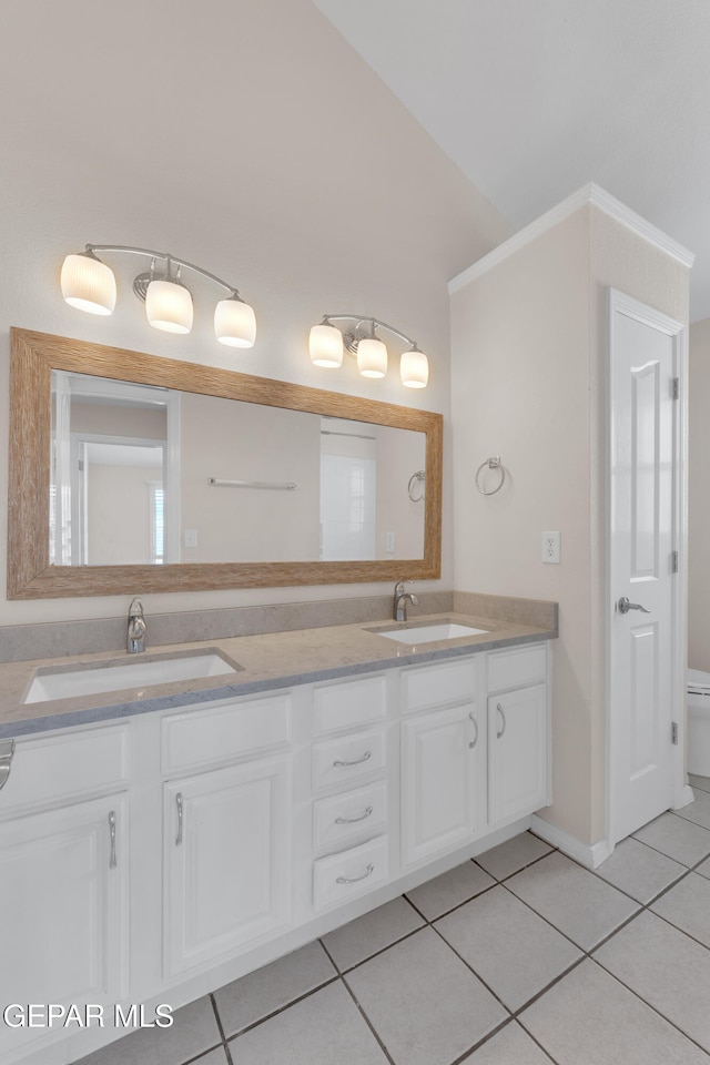 full bathroom featuring a sink, double vanity, and tile patterned flooring