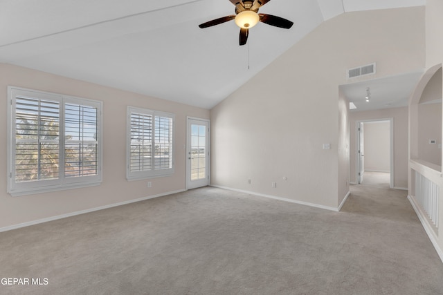 spare room featuring baseboards, light carpet, high vaulted ceiling, and a ceiling fan