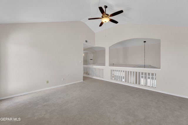 spare room featuring visible vents, carpet flooring, ceiling fan, and vaulted ceiling