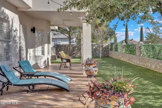 wooden terrace with a yard and a fenced backyard