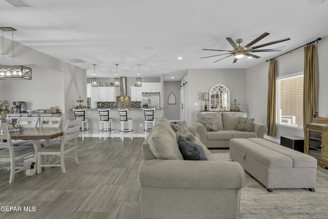 living room featuring recessed lighting, visible vents, wood finish floors, and ceiling fan