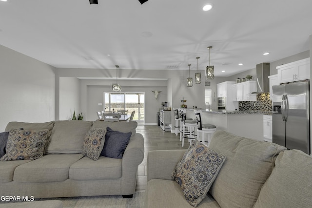 living area with recessed lighting and baseboards