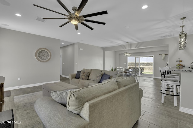 living area with wood finish floors, recessed lighting, visible vents, and ceiling fan