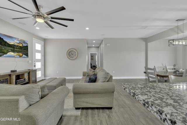 living room featuring recessed lighting, baseboards, and ceiling fan