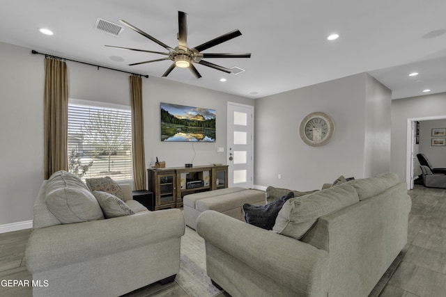 living room with visible vents, recessed lighting, and a ceiling fan