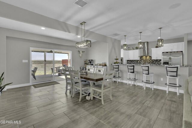 dining room with recessed lighting, baseboards, visible vents, and wood finish floors