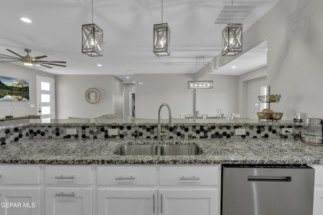 kitchen featuring visible vents, white cabinets, dishwasher, and a sink