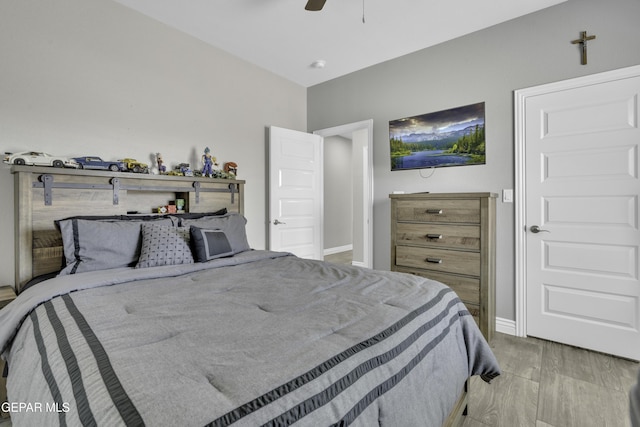 bedroom featuring baseboards, ceiling fan, and light wood finished floors