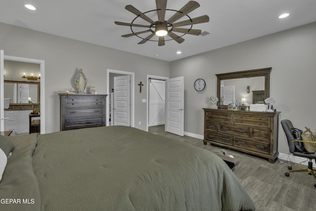 bedroom featuring wood finished floors, recessed lighting, and baseboards