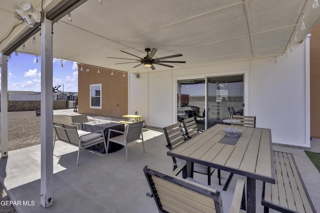 view of patio / terrace featuring outdoor dining space, fence, and ceiling fan