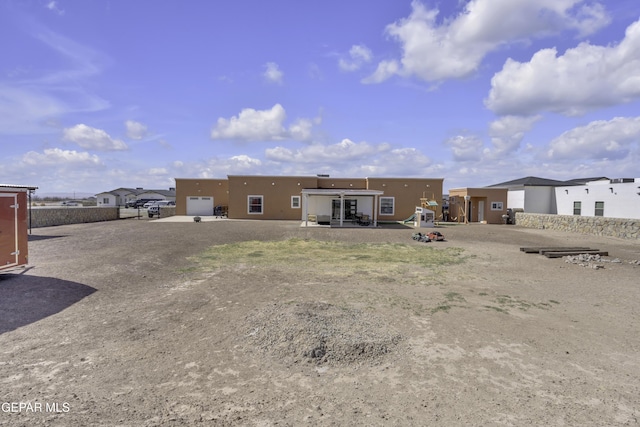 rear view of property with stucco siding