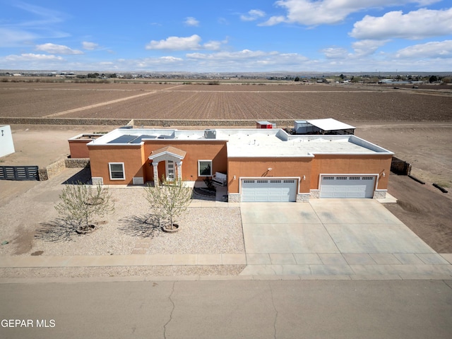 view of front facade with stucco siding, driveway, and an attached garage