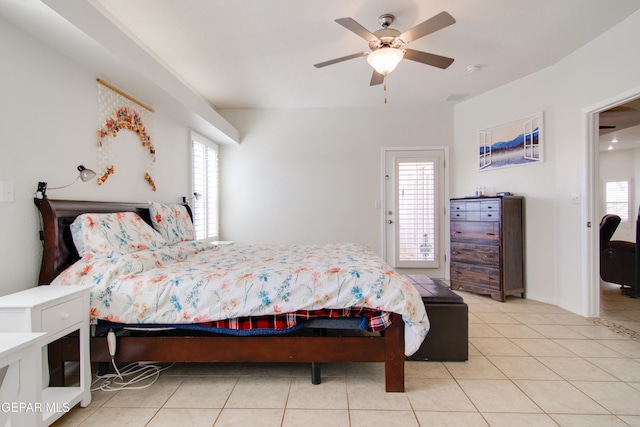 bedroom with light tile patterned floors, a ceiling fan, and baseboards