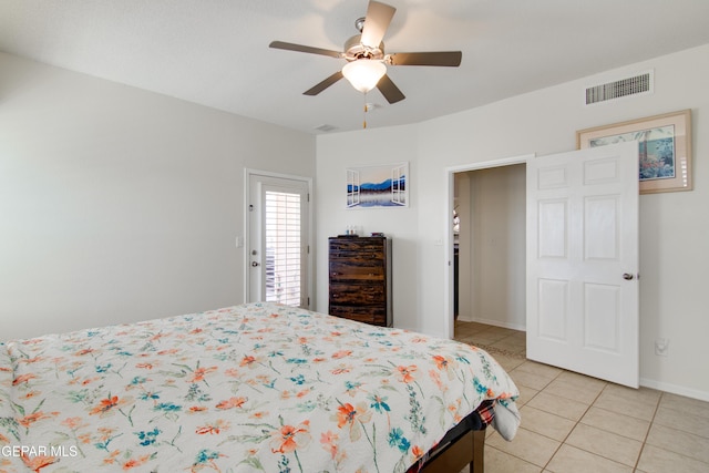 bedroom with light tile patterned flooring, visible vents, baseboards, and a ceiling fan